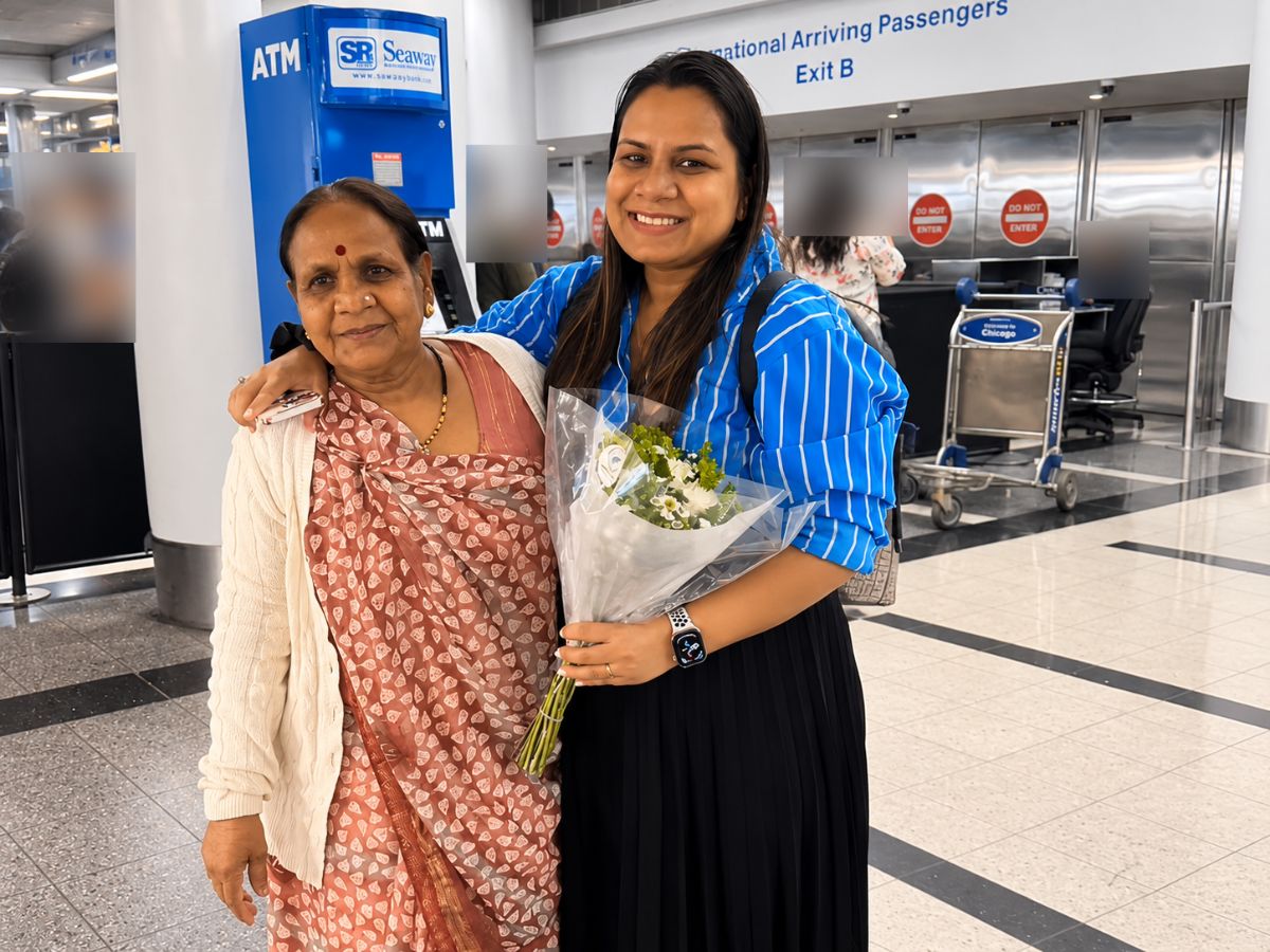 A mother is welcomed by her daughter at Chicago O'Hare arrivals.